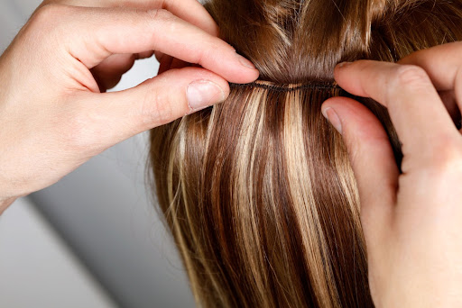 Image of some hair extensions being placed in natural hair